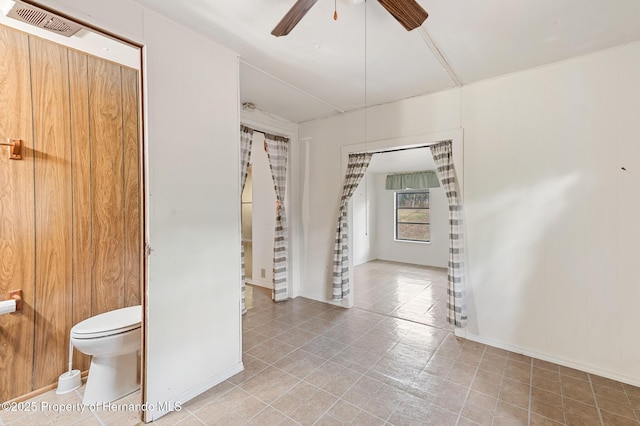 interior space featuring visible vents and ceiling fan