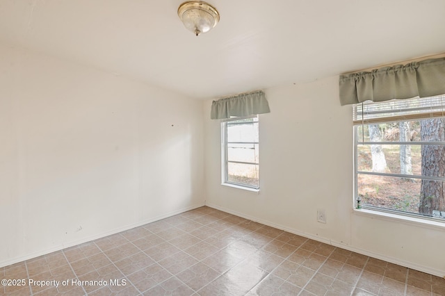 spare room featuring baseboards