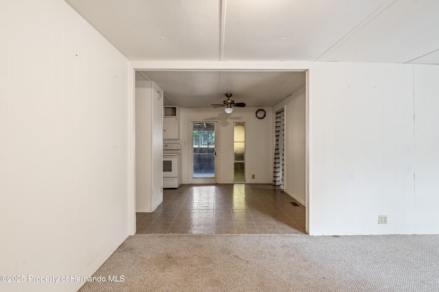 hallway with tile patterned floors and carpet