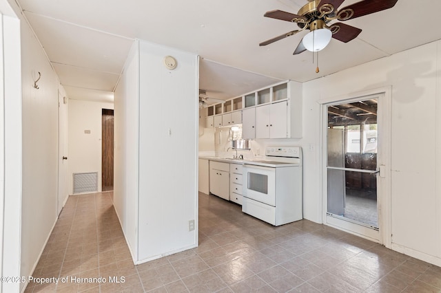 kitchen with white cabinets, electric stove, a ceiling fan, and visible vents