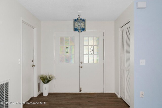 entrance foyer featuring visible vents, french doors, and dark wood-style flooring