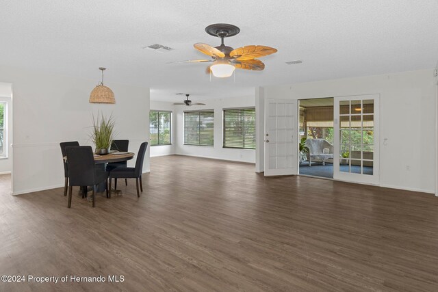 dining room featuring visible vents, baseboards, a textured ceiling, and dark wood-style flooring