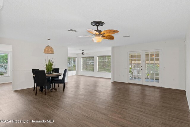 dining area featuring visible vents, baseboards, a textured ceiling, and dark wood-style flooring