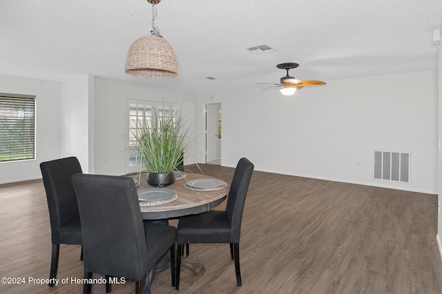 dining room with visible vents, plenty of natural light, and wood finished floors