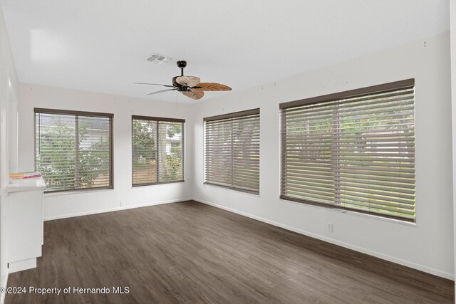 unfurnished sunroom featuring visible vents and a ceiling fan