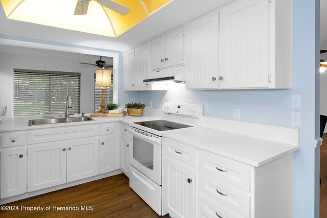 kitchen featuring white range with electric cooktop, a sink, under cabinet range hood, ceiling fan, and dark wood-style flooring