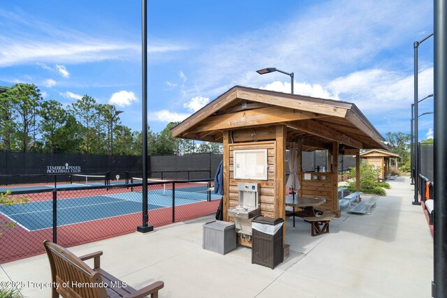 view of sport court featuring fence