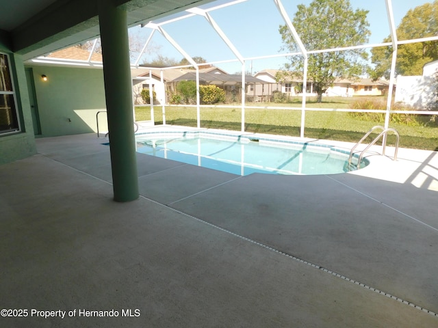 outdoor pool with glass enclosure, a patio, a yard, and a residential view