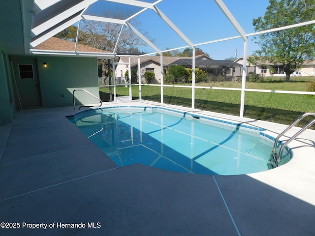 outdoor pool featuring a patio area, a residential view, glass enclosure, and a yard