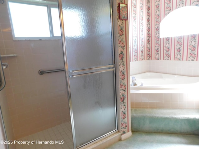 full bathroom featuring a shower stall, wallpapered walls, and a garden tub