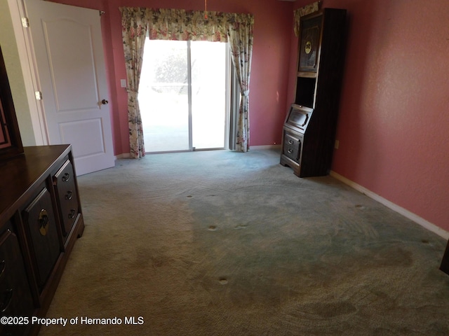 carpeted empty room with baseboards