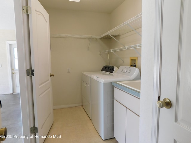 washroom with cabinet space and washing machine and clothes dryer