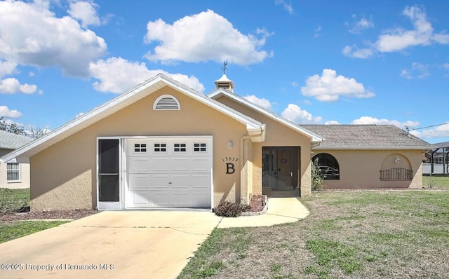 single story home featuring stucco siding, an attached garage, driveway, and a front lawn