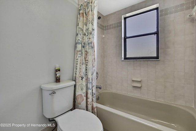 bathroom with toilet and shower / bath combo