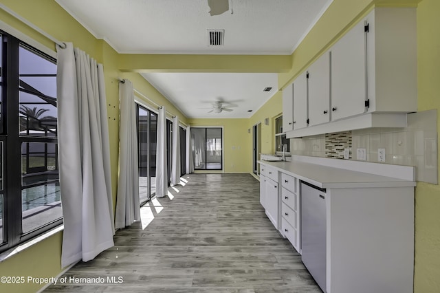 kitchen featuring a ceiling fan, light wood-style flooring, light countertops, white cabinetry, and visible vents