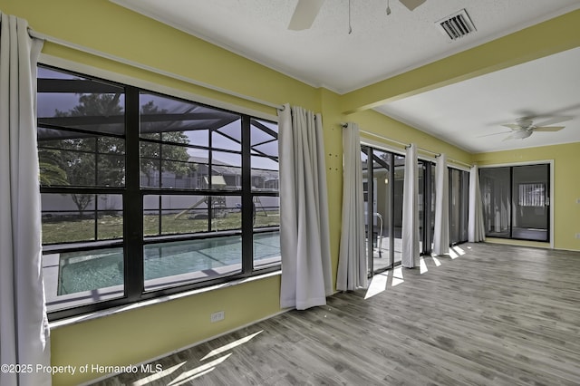 unfurnished sunroom with visible vents and a healthy amount of sunlight