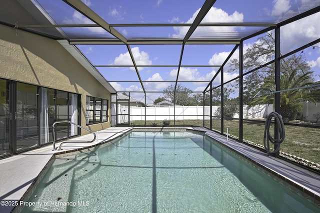 view of swimming pool with a lanai, fence, a patio area, and a fenced in pool