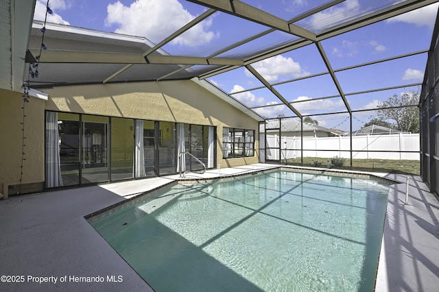 view of swimming pool featuring a lanai, fence, a patio, and a fenced in pool