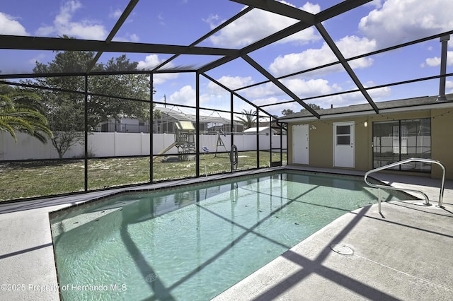 view of swimming pool with a lanai, fence, a patio area, and a fenced in pool
