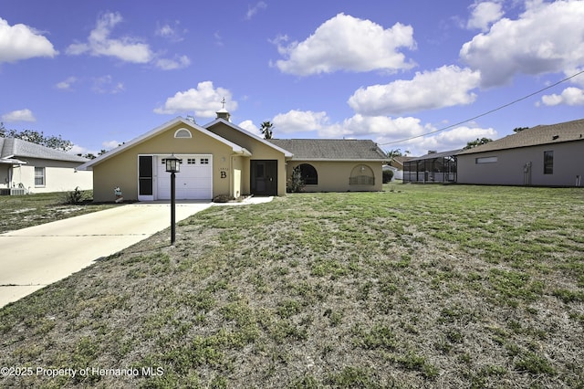 ranch-style home with stucco siding, driveway, a front yard, and a garage