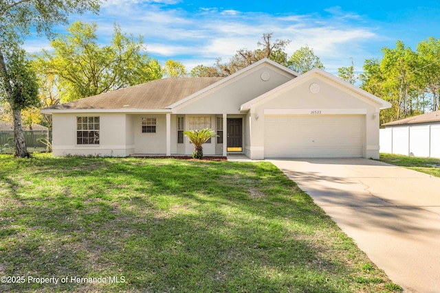 single story home with a front lawn, fence, concrete driveway, stucco siding, and a garage