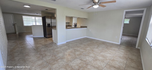 16402 Killearn Ln, Spring Hill Pasco, FL 34610 - empty room featuring a ceiling fan, a sink, light tile patterned floors, and baseboards