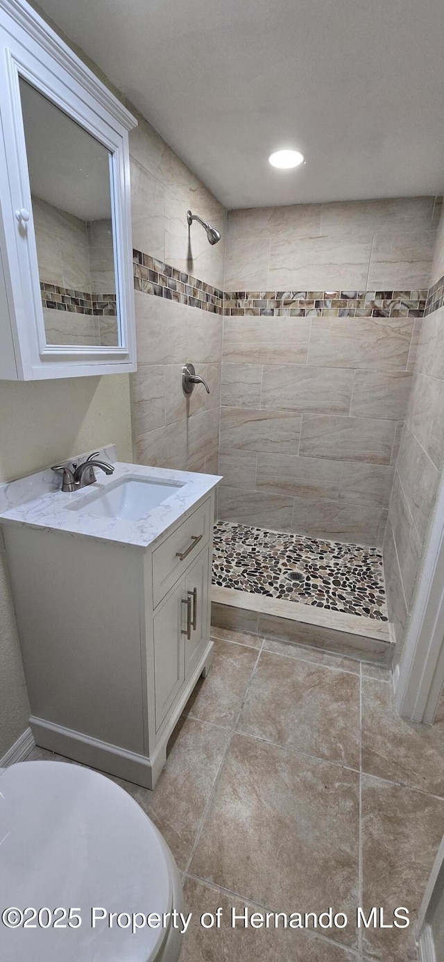 16402 Killearn Ln, Spring Hill Pasco, FL 34610 - bathroom featuring tiled shower and vanity