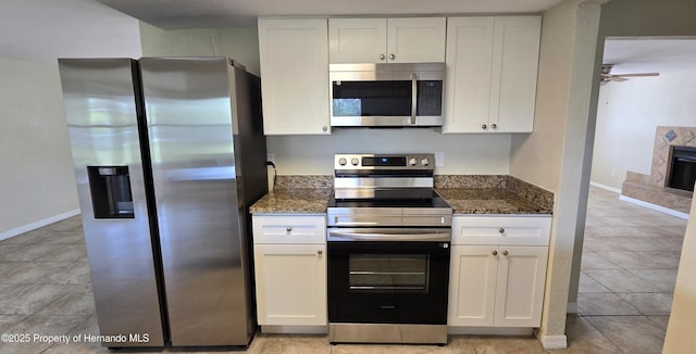 16402 Killearn Ln, Spring Hill Pasco, FL 34610 - kitchen with appliances with stainless steel finishes, dark stone counters, white cabinets, and ceiling fan