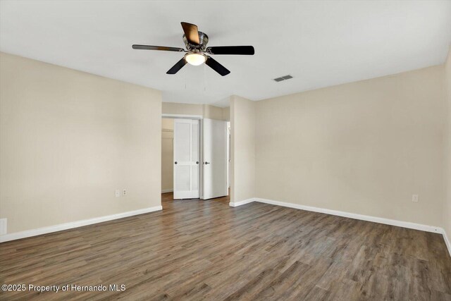 unfurnished bedroom featuring visible vents, baseboards, and wood finished floors