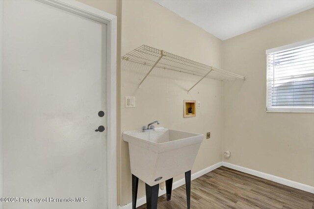 laundry area featuring wood finished floors, baseboards, hookup for an electric dryer, laundry area, and washer hookup