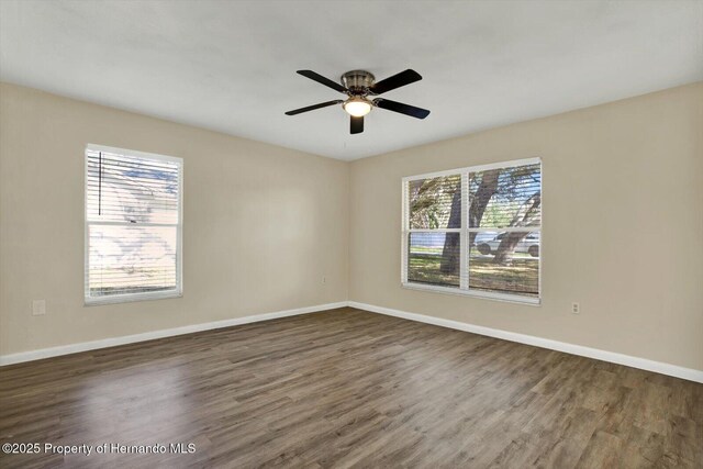 spare room with ceiling fan, baseboards, and wood finished floors