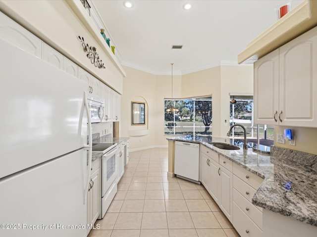 kitchen with visible vents, a sink, white appliances, crown molding, and light tile patterned floors