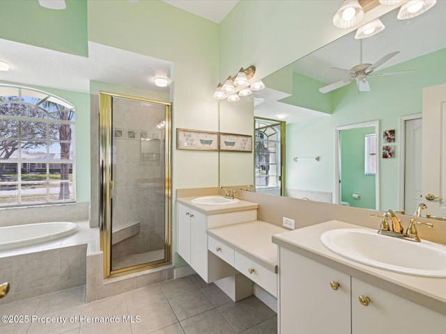 bathroom with tile patterned flooring, a shower stall, and vanity