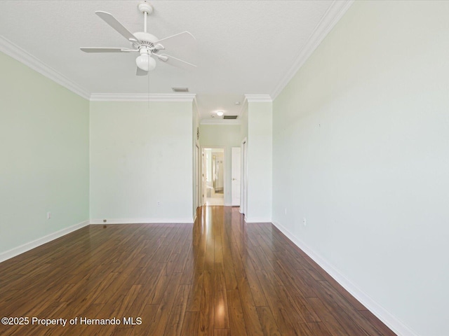 empty room featuring dark wood finished floors, a ceiling fan, baseboards, and ornamental molding