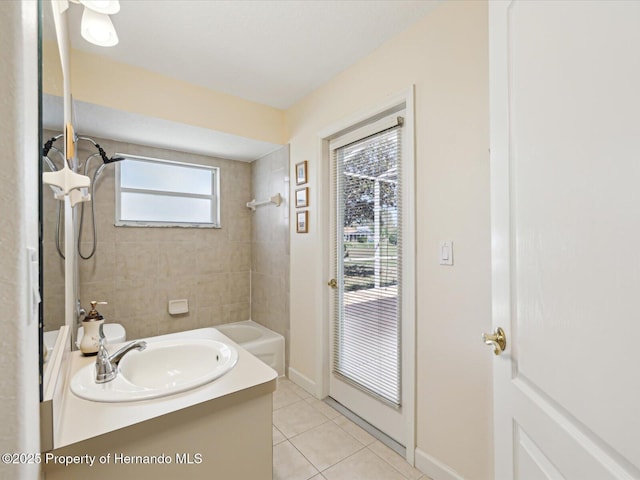 bathroom with tile patterned flooring, shower / tub combination, vanity, and baseboards