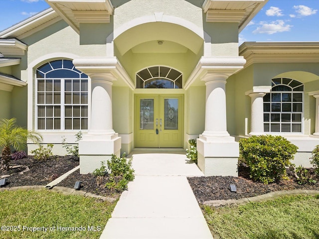 doorway to property with stucco siding and french doors