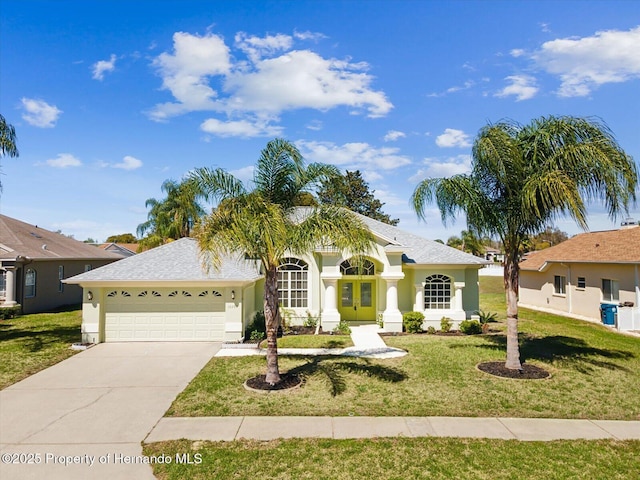 view of front of property featuring stucco siding, a front lawn, concrete driveway, and an attached garage