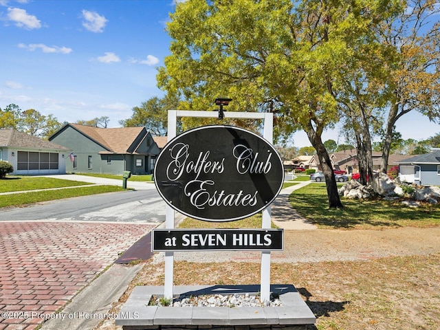 community / neighborhood sign with a residential view