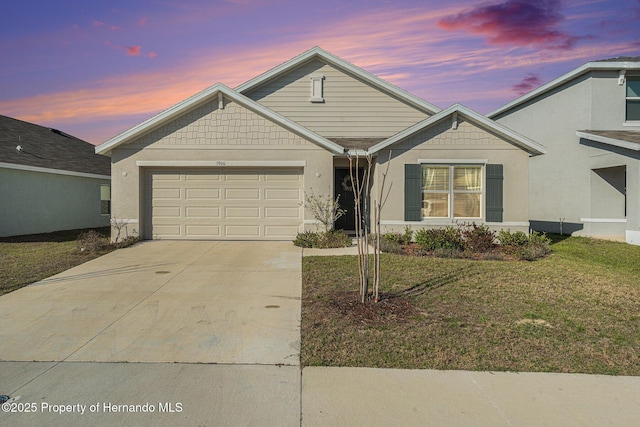 ranch-style house featuring concrete driveway, a yard, a garage, and stucco siding