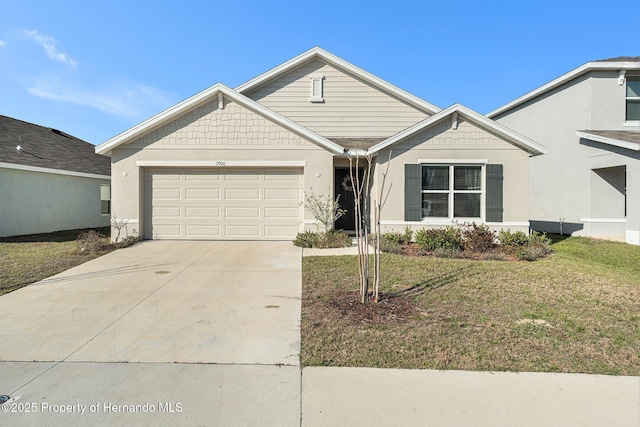 view of front facade featuring a front lawn, a garage, and driveway