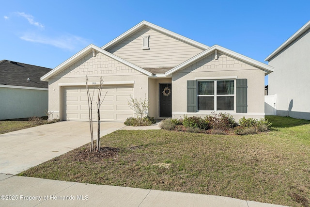 view of front facade with a garage, concrete driveway, and a front lawn