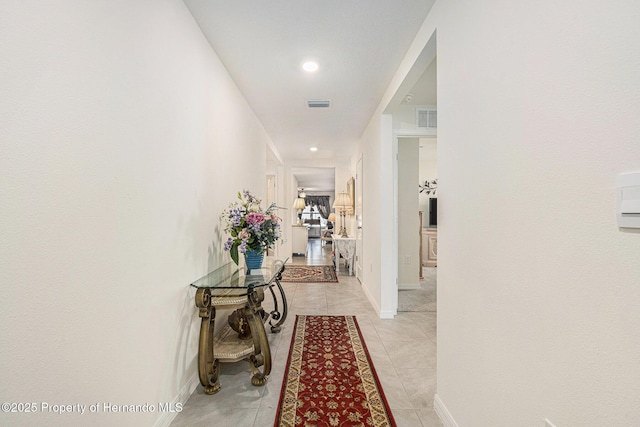 hall with recessed lighting, light tile patterned floors, baseboards, and visible vents