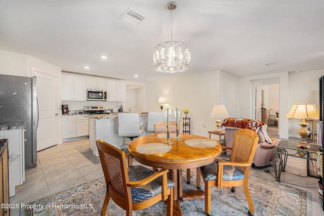 dining room featuring a notable chandelier, recessed lighting, visible vents, and light tile patterned floors