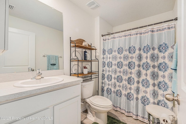 bathroom featuring visible vents, a textured ceiling, toilet, and vanity