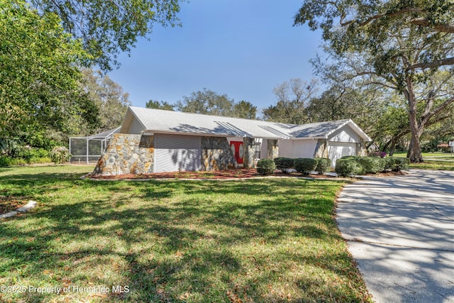 view of front of property with a lanai and a front lawn