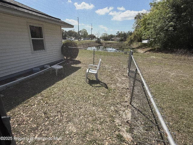 view of yard with fence and a water view