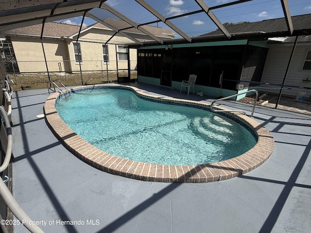 outdoor pool with a patio area and a lanai