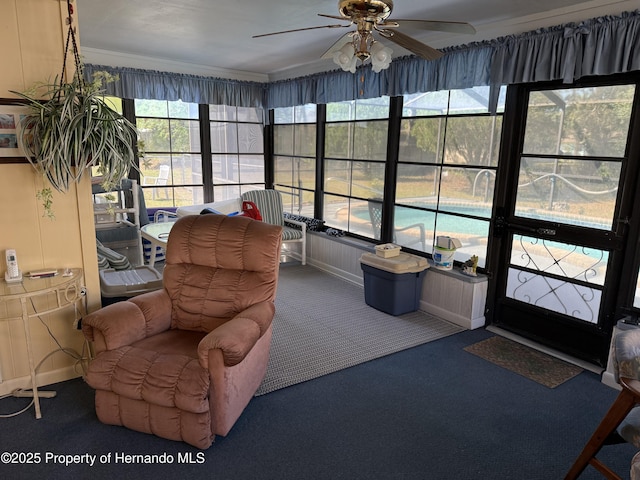 sunroom / solarium with a ceiling fan