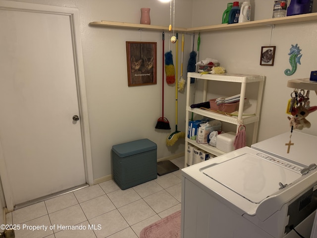 laundry area with laundry area and light tile patterned floors