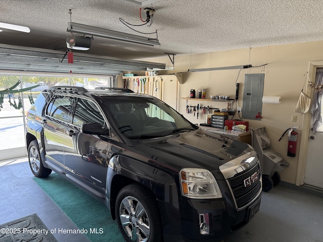 garage with electric panel and a garage door opener